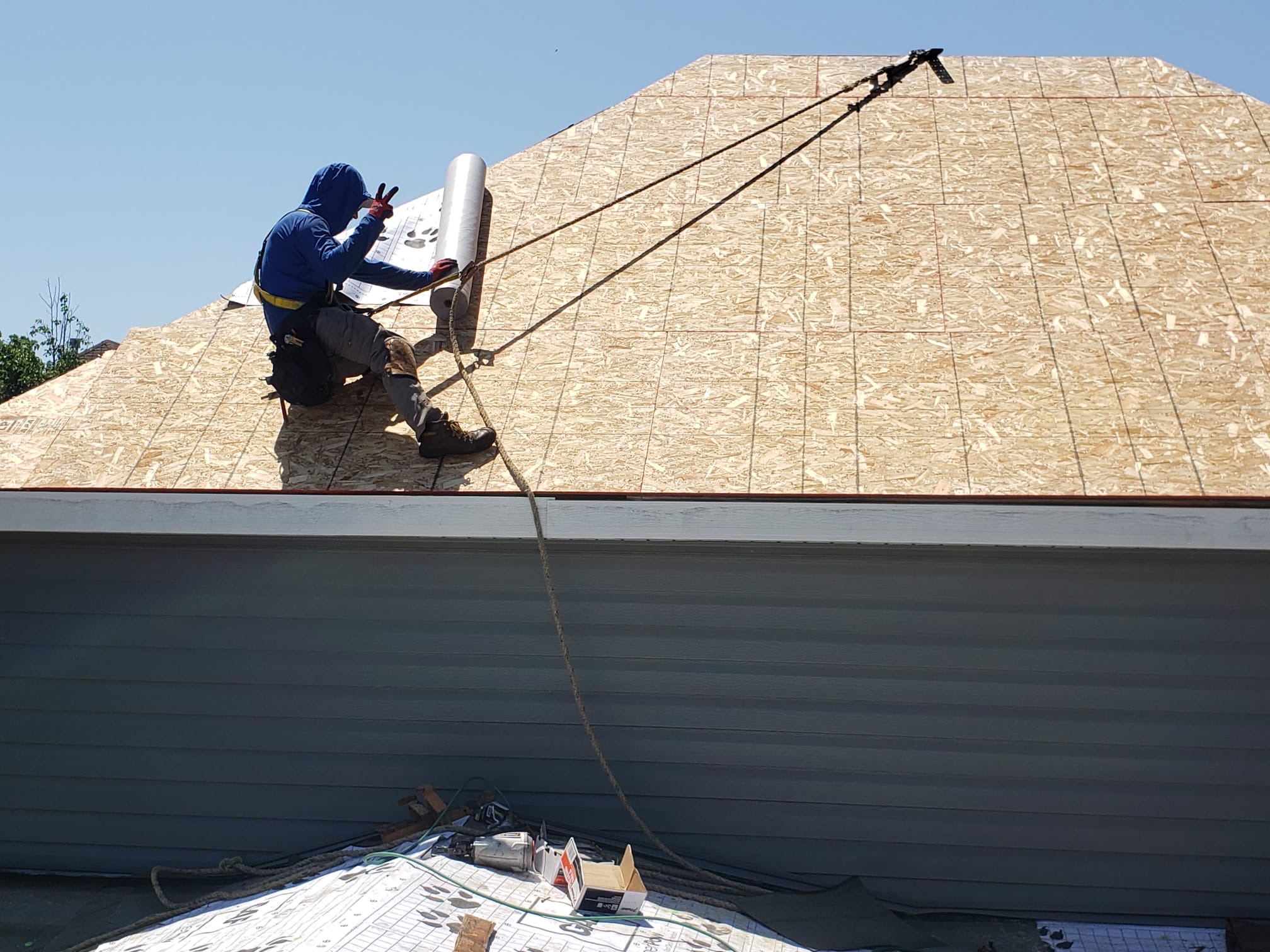 Madison, WI roof stripped to fresh decking with synthetic underlayment being installed